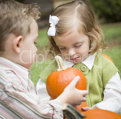 Cute Young Brother and Sister At the Pumpkin Patch