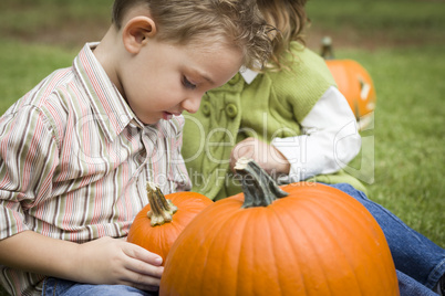 Cute Young Brother and Sister At the Pumpkin Patch