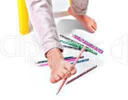 Child's feet  performing gymnastic with pencils