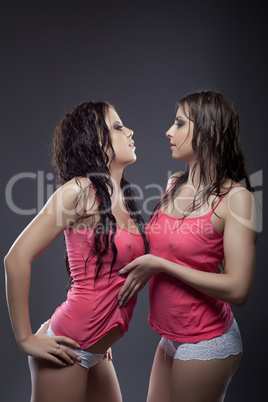 couple of sexy girls posing in wet tank top