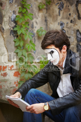Mime guy reads his book