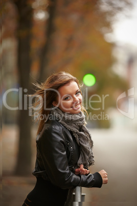 Beautiful girl in autumn city
