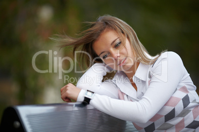 Beautiful girl sitting on the bench