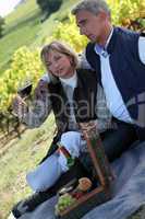 couple having picnic in the vineyard