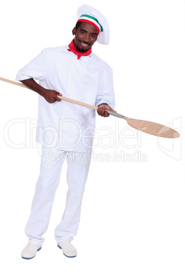 young black pizza cook taking a spade
