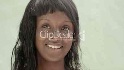 Beautiful black female teen smiling and looking at camera