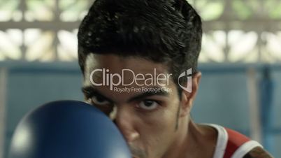 Young hispanic man exercising in boxing gym
