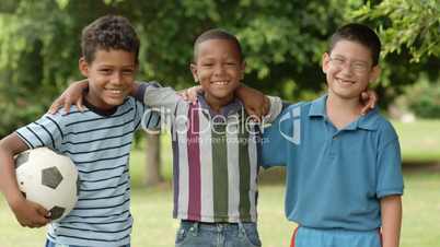 Multiethnic group of happy male friends with soccer ball