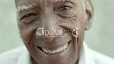 Closeup of happy old black man smiling at camera