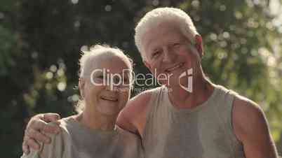 Portrait of elderly couple after fitness in park