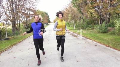 two woman talking and jogging