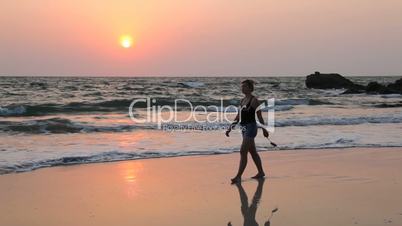 Young woman walk Ngapali beach during sunset, Myanmar