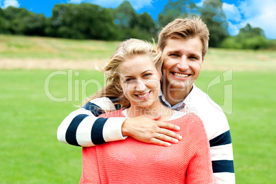 Husband hugging his wife from back