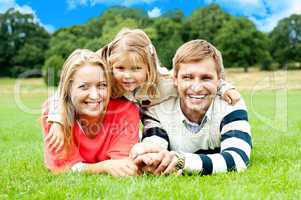 Happy young family with daughter outdoors