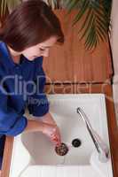 Female plumber installing a sink