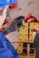 Electrician preparing bracket