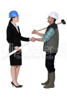 craftsman and businesswoman shaking hands