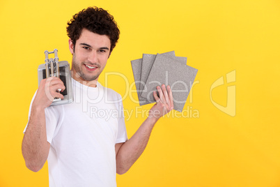 Young man with a tile cutter