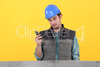 Worker behind wall