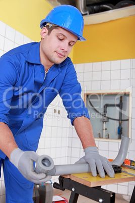 Plumber installing water pipes