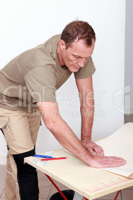 a handyman bending a covering