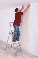 Man laying wall paper