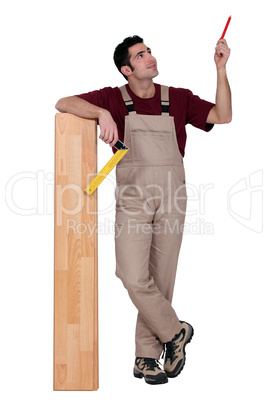 portrait of carpenter with parquet looking upwards