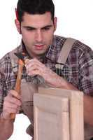 Man using hammer and chisel