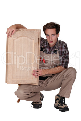 woodworker holding a window frame