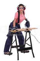 Woman cutting plank of wood with band saw