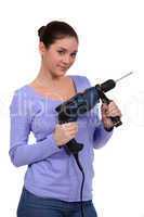 girl posing with drill