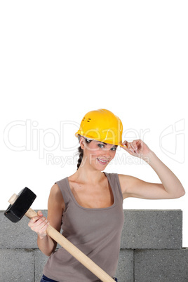 Woman with helmet and mallet in hand