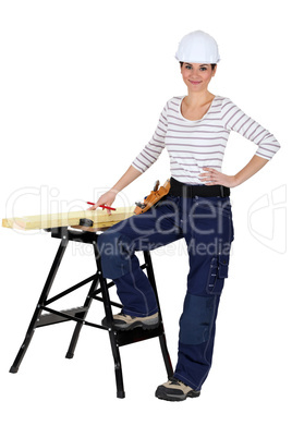 female carpenter and workbench isolated on white