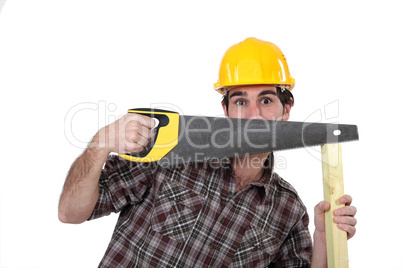 Tradesman hiding behind a saw