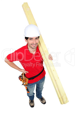 high angle shot portrait of craftsman carrying lumber