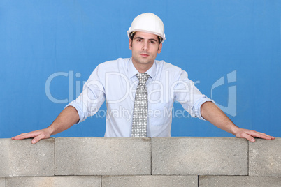 Engineer standing over a stone wall