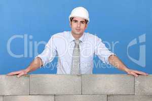 Engineer standing over a stone wall
