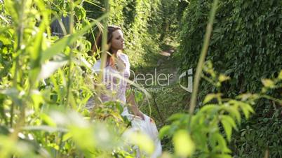 Beautiful girl goes through a high grass