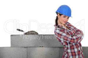 Stonemason standing proudly next to her work