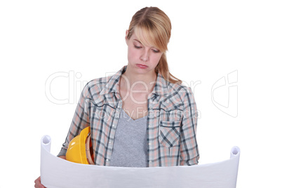 Female architect checking construction plans