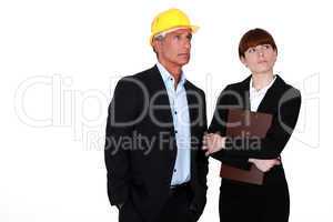 real estate businessman and assistant looking at something