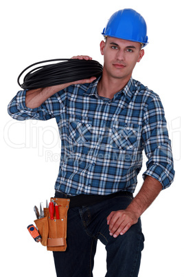 Electrician carrying spool of wiring