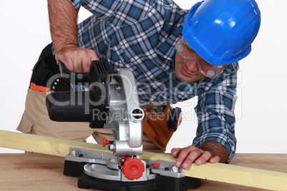 Tradesman using a mitre saw
