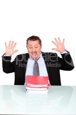 Man shocked at his pile of paperwork