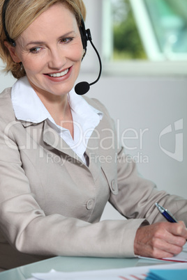 Woman smiling with headset.