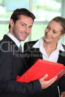 Businesswoman smiling at businessman