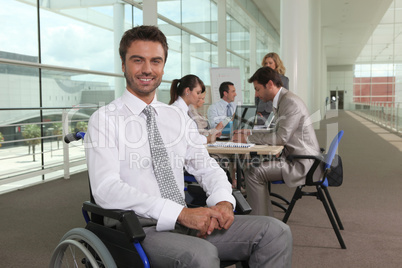 Disabled office worker with colleagues