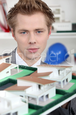 young architect posing with model
