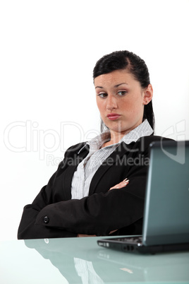 bored businesswoman looking at her laptop