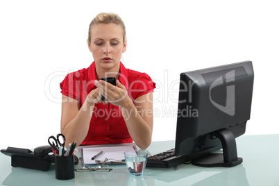 Blond receptionist typing text message